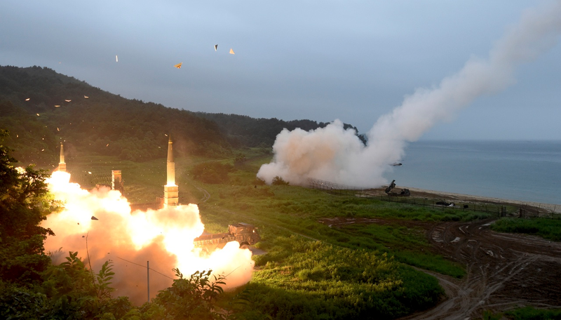 In this photo provided by South Korea Defense Ministry, South Korea’s Hyunmoo II Missile system, left, and U.S. Army Tactical Missile System, right, fire missiles during the combined military exercise between the two countries against North Korea at an undisclosed location in South Korea, Saturday, July 29, 2017. (South Korea Defense Ministry via AP)
